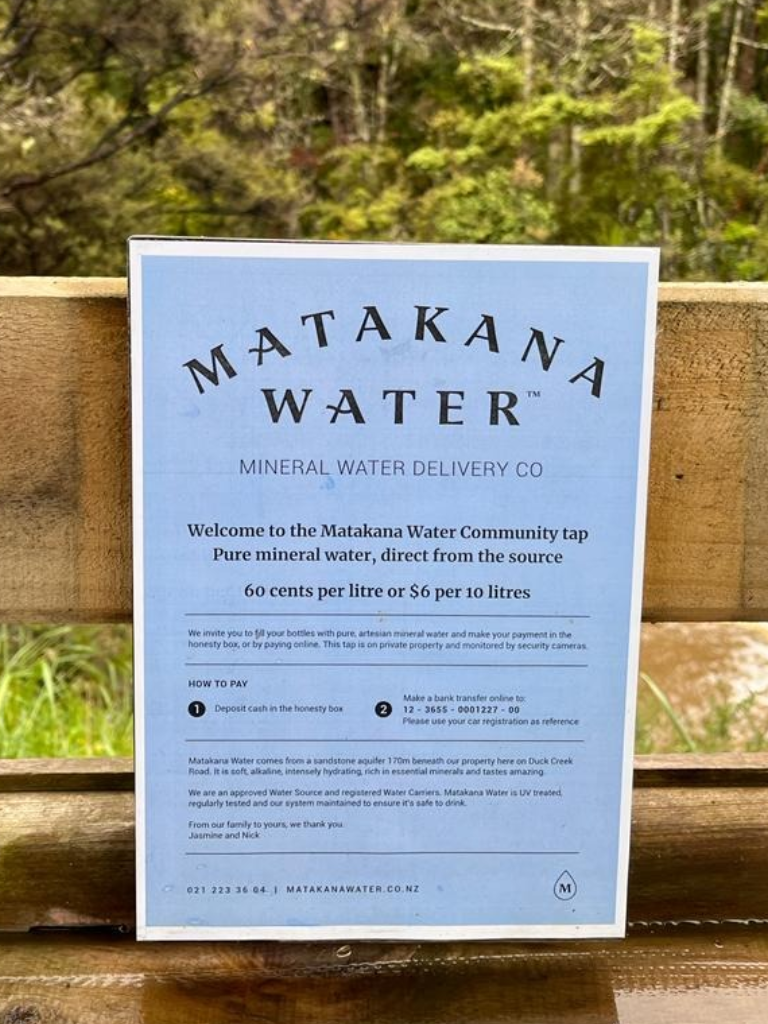 Sign at the Community Tap with pricing (60c per litre or $6 per 10 litres) and honesty box payment instructions